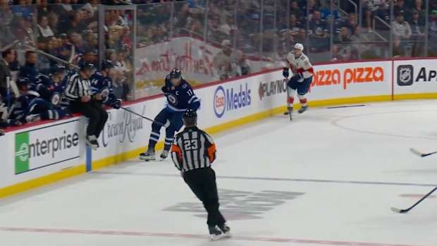 Adam Lowry gets a stick from the bench